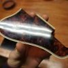 old pickguard is cracked due to age